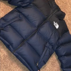 Blue and black north face jacket